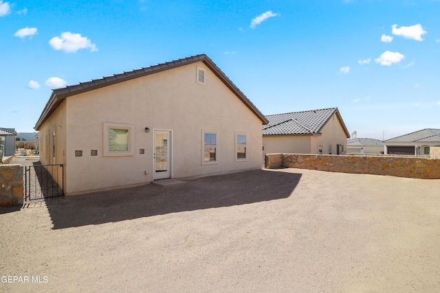 245 Hunstanton St, Horizon City, TX 79928 - back of house featuring stucco siding, a patio, and a tiled roof