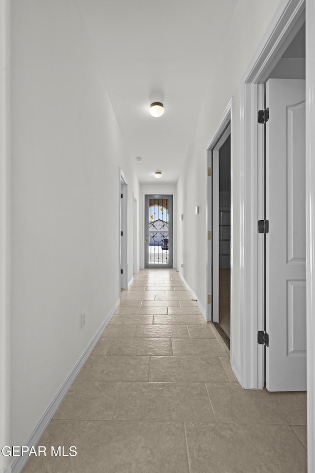 245 Hunstanton St, Horizon City, TX 79928 - hallway with baseboards and stone tile floors
