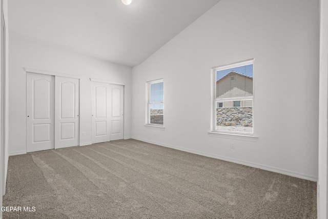245 Hunstanton St, Horizon City, TX 79928 - unfurnished bedroom with multiple closets, carpet, and high vaulted ceiling