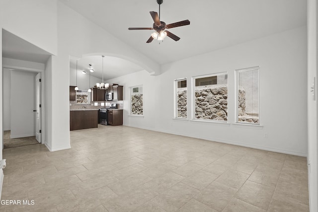 245 Hunstanton St, Horizon City, TX 79928 - unfurnished living room featuring a chandelier, a ceiling fan, high vaulted ceiling, and arched walkways