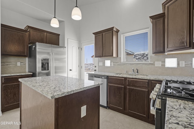 245 Hunstanton St, Horizon City, TX 79928 - kitchen with stainless steel appliances, decorative backsplash, and dark brown cabinets