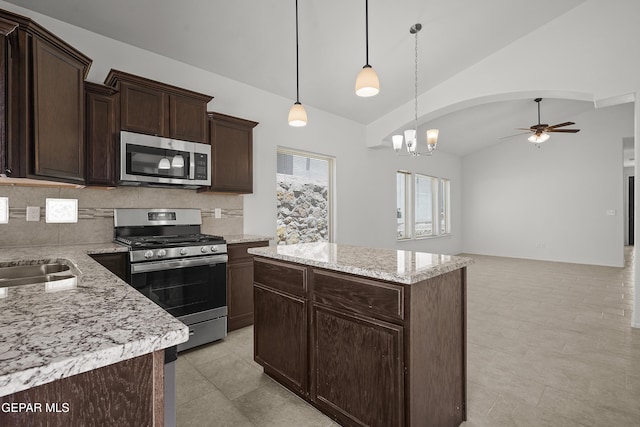 245 Hunstanton St, Horizon City, TX 79928 - kitchen featuring stainless steel appliances, ceiling fan, dark brown cabinetry, a center island, and decorative backsplash