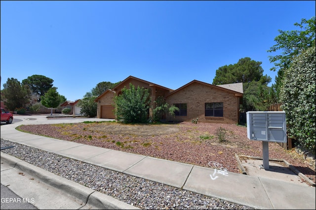 712 Rena Mae Ct, Las Cruces, NM 88005 - view of front of house with brick siding, an attached garage, and driveway