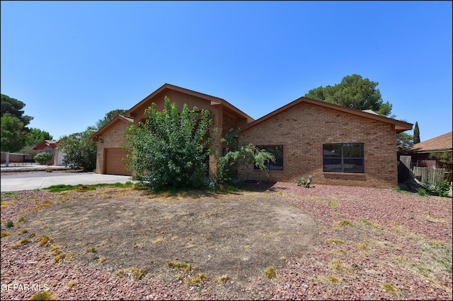 712 Rena Mae Ct, Las Cruces, NM 88005 - view of front of house with brick siding, concrete driveway, and an attached garage