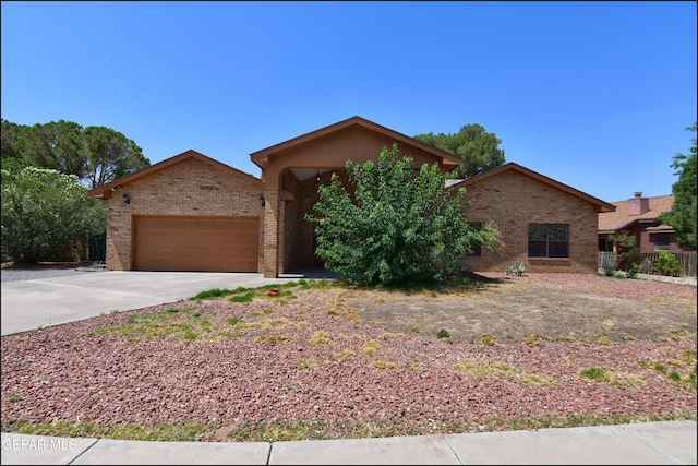 712 Rena Mae Ct, Las Cruces, NM 88005 - view of front of property featuring brick siding, concrete driveway, and a garage