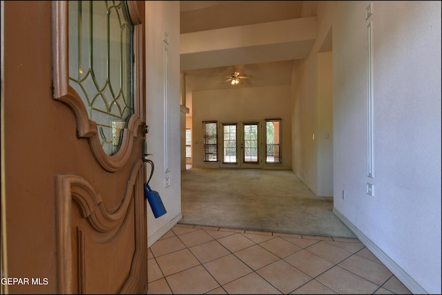 712 Rena Mae Ct, Las Cruces, NM 88005 - entryway featuring light colored carpet, ceiling fan, light tile patterned floors, and a towering ceiling