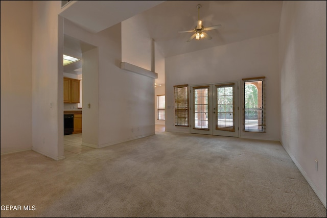 712 Rena Mae Ct, Las Cruces, NM 88005 - unfurnished living room with light carpet, a high ceiling, ceiling fan, and french doors