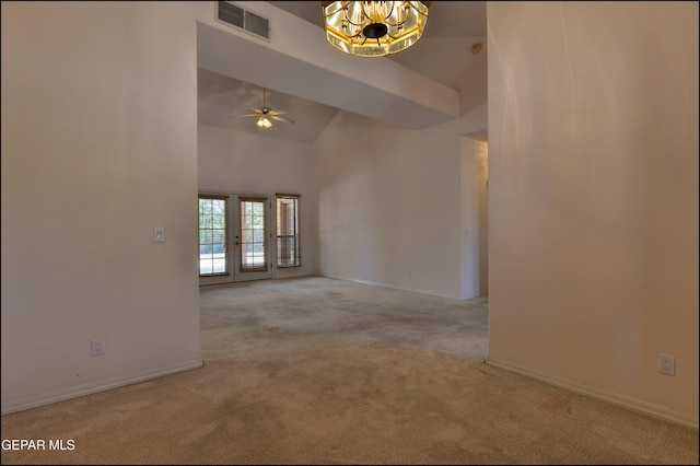 712 Rena Mae Ct, Las Cruces, NM 88005 - carpeted empty room featuring a ceiling fan, high vaulted ceiling, a chandelier, and french doors