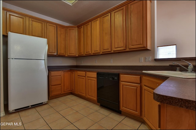 712 Rena Mae Ct, Las Cruces, NM 88005 - kitchen with freestanding refrigerator, black dishwasher, dark countertops, light tile patterned flooring, and brown cabinetry