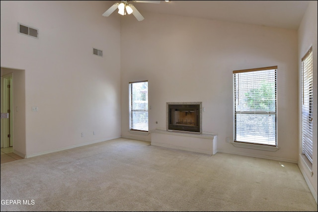 712 Rena Mae Ct, Las Cruces, NM 88005 - unfurnished living room featuring light carpet, high vaulted ceiling, healthy amount of natural light, a ceiling fan, and a fireplace
