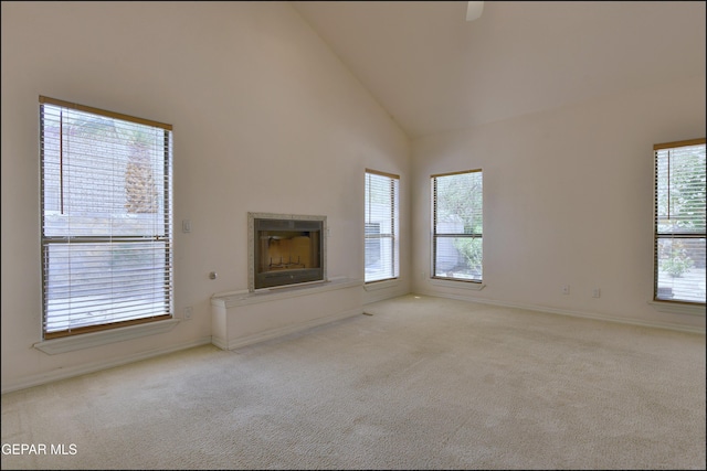 712 Rena Mae Ct, Las Cruces, NM 88005 - unfurnished living room with carpet floors, high vaulted ceiling, and a fireplace with raised hearth