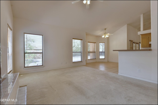 712 Rena Mae Ct, Las Cruces, NM 88005 - unfurnished living room featuring ceiling fan, lofted ceiling, light carpet, and light tile patterned flooring