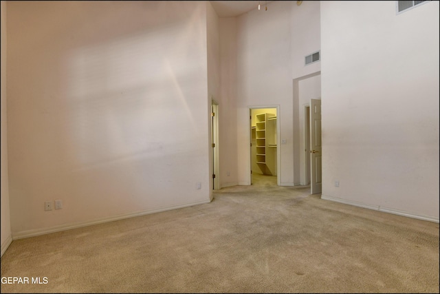 712 Rena Mae Ct, Las Cruces, NM 88005 - carpeted empty room featuring a high ceiling and baseboards