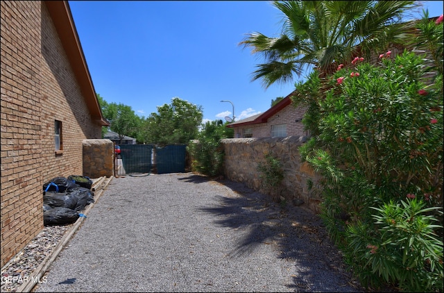 712 Rena Mae Ct, Las Cruces, NM 88005 - view of side of property featuring brick siding and a gate