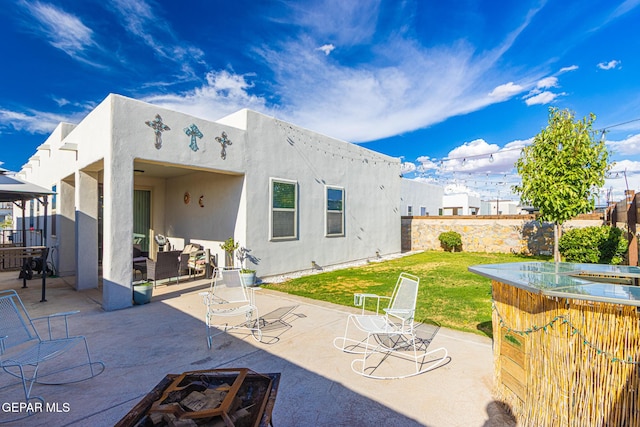 13010 Aberdare Dr, El Paso, TX 79928 - back of house with stucco siding, a patio area, an outdoor fire pit, and a gazebo