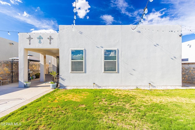 13010 Aberdare Dr, El Paso, TX 79928 - view of property exterior featuring a lawn, a patio, and stucco siding