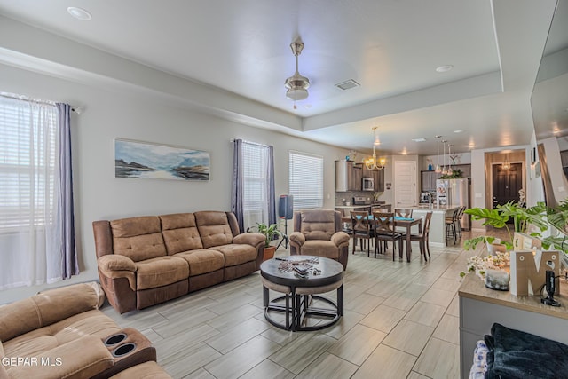 13010 Aberdare Dr, El Paso, TX 79928 - living room with a tray ceiling, a chandelier, recessed lighting, and wood tiled floors