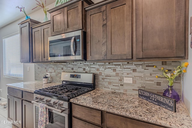 13010 Aberdare Dr, El Paso, TX 79928 - kitchen featuring stainless steel appliances, backsplash, light stone countertops, and dark brown cabinetry