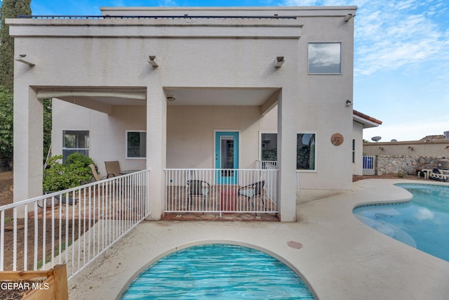 1121 Regal Ridge Dr, El Paso, TX 79912 - back of house with stucco siding and a patio area