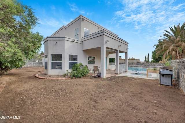 1121 Regal Ridge Dr, El Paso, TX 79912 - rear view of property with a balcony, a patio area, and stucco siding