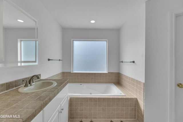 1121 Regal Ridge Dr, El Paso, TX 79912 - full bath featuring vanity, a tub with jets, healthy amount of natural light, and recessed lighting