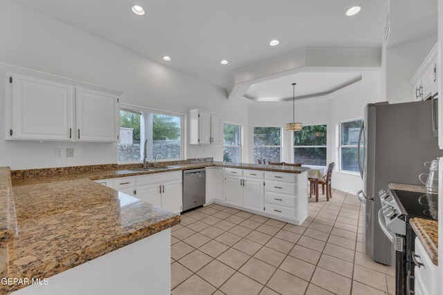 1121 Regal Ridge Dr, El Paso, TX 79912 - kitchen featuring stainless steel appliances, a peninsula, white cabinets, recessed lighting, and light tile patterned flooring
