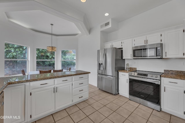 1121 Regal Ridge Dr, El Paso, TX 79912 - kitchen featuring stainless steel appliances, white cabinets, light tile patterned floors, decorative light fixtures, and dark stone counters