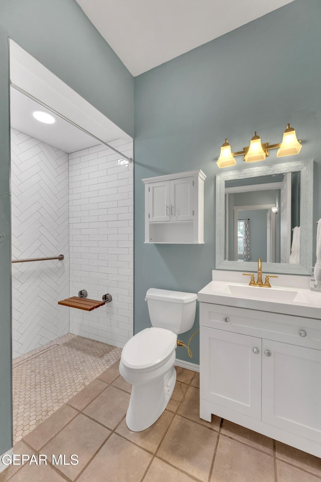 1121 Regal Ridge Dr, El Paso, TX 79912 - bathroom featuring vanity, tile patterned floors, and a tile shower