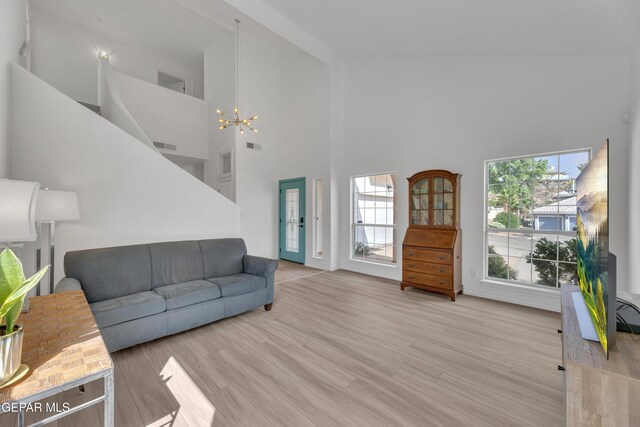 1121 Regal Ridge Dr, El Paso, TX 79912 - living area with a chandelier, high vaulted ceiling, and light wood-type flooring
