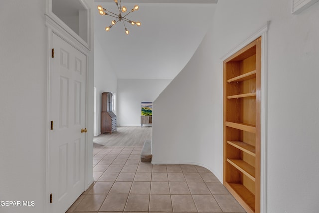 1121 Regal Ridge Dr, El Paso, TX 79912 - hallway with light tile patterned floors, a chandelier, built in features, and high vaulted ceiling