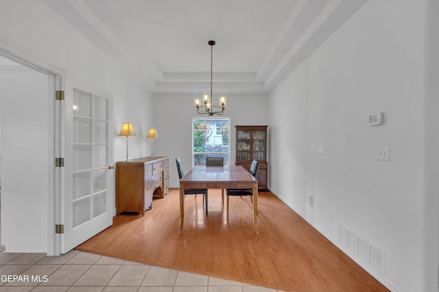 1121 Regal Ridge Dr, El Paso, TX 79912 - dining room with light tile patterned floors, a chandelier, and a tray ceiling