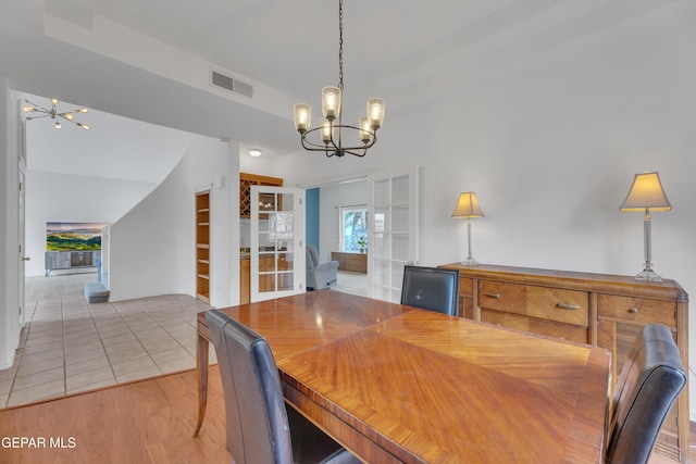1121 Regal Ridge Dr, El Paso, TX 79912 - dining room featuring a chandelier and light wood-style flooring