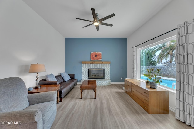 1121 Regal Ridge Dr, El Paso, TX 79912 - living room with a ceiling fan, light wood-style floors, and a tile fireplace