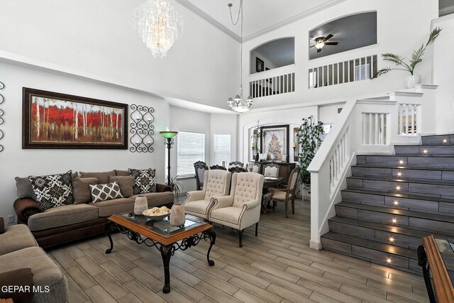 12301 Tierra Limpa Dr, El Paso, TX 79938 - living area featuring a towering ceiling, a chandelier, stairway, wood finished floors, and ceiling fan