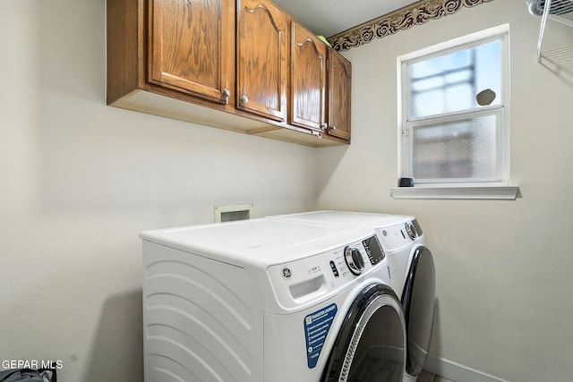 12301 Tierra Limpa Dr, El Paso, TX 79938 - laundry room with cabinet space and washing machine and clothes dryer
