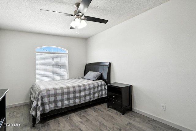 12301 Tierra Limpa Dr, El Paso, TX 79938 - bedroom featuring wood finished floors, a textured ceiling, and a ceiling fan