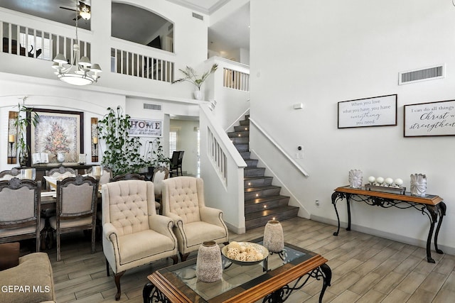 12301 Tierra Limpa Dr, El Paso, TX 79938 - living area featuring wood finished floors, stairway, a towering ceiling, and ceiling fan
