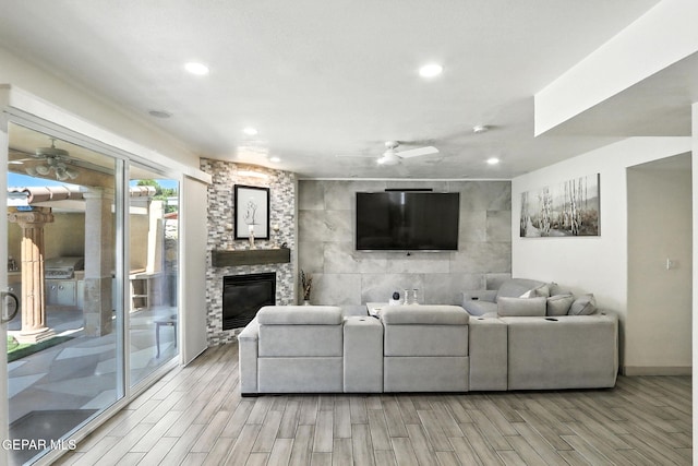 12301 Tierra Limpa Dr, El Paso, TX 79938 - living room with a ceiling fan, wood tiled floors, a large fireplace, and recessed lighting