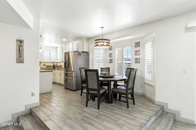 12301 Tierra Limpa Dr, El Paso, TX 79938 - dining room with wood tiled floors, healthy amount of natural light, a chandelier, and recessed lighting