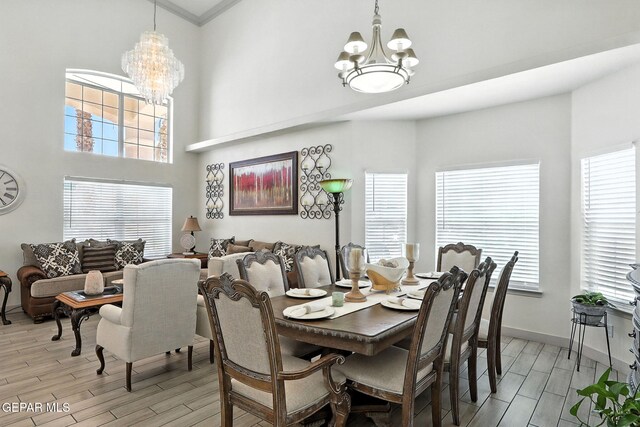 12301 Tierra Limpa Dr, El Paso, TX 79938 - dining room featuring a chandelier, light wood-style floors, plenty of natural light, a high ceiling, and ornamental molding