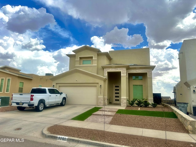 7780 Enchanted Park Dr, El Paso, TX 79911 - view of front facade with driveway, stucco siding, stone siding, and an attached garage