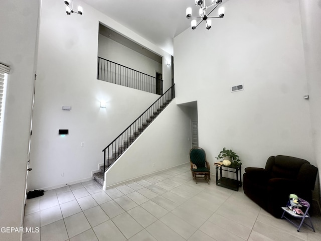 7780 Enchanted Park Dr, El Paso, TX 79911 - stairs featuring a towering ceiling, a chandelier, and tile patterned floors