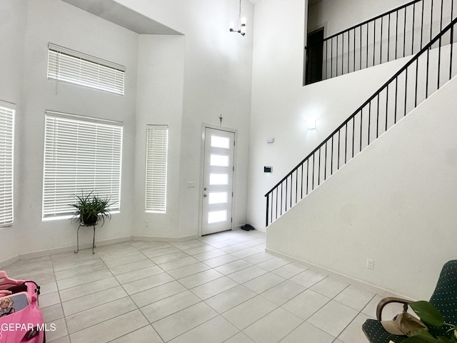 7780 Enchanted Park Dr, El Paso, TX 79911 - foyer with a high ceiling, tile patterned floors, and stairway