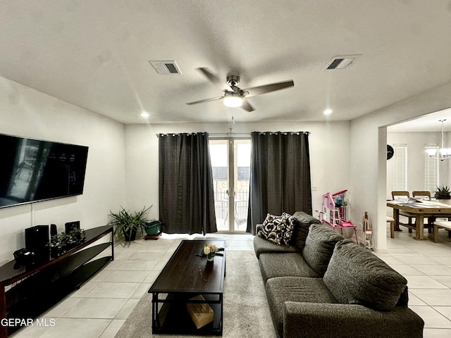 7780 Enchanted Park Dr, El Paso, TX 79911 - living room featuring light tile patterned floors, a ceiling fan, recessed lighting, a chandelier, and a textured ceiling