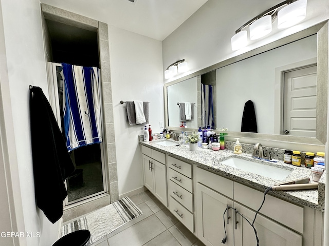 7780 Enchanted Park Dr, El Paso, TX 79911 - full bathroom with a shower stall, double vanity, and tile patterned flooring