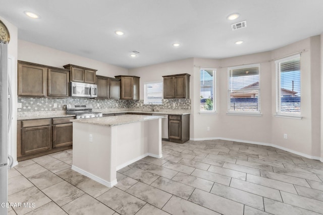 541 Sunset Valley Ave, Socorro, TX 79927 - kitchen featuring appliances with stainless steel finishes, healthy amount of natural light, tasteful backsplash, a center island, and recessed lighting