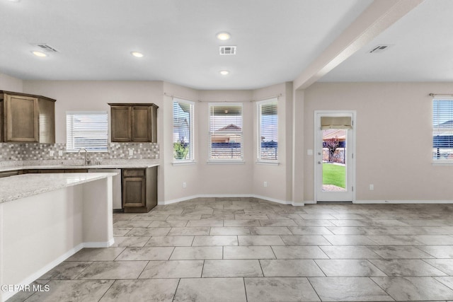 541 Sunset Valley Ave, Socorro, TX 79927 - kitchen with healthy amount of natural light, tasteful backsplash, recessed lighting, stainless steel dishwasher, and dark brown cabinetry