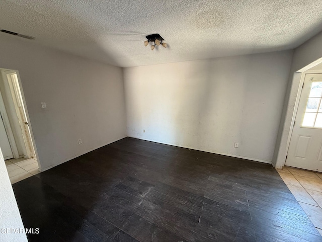 11711 Flor Del Rio St, Socorro, TX 79927 - unfurnished dining area featuring hardwood / wood-style flooring and a textured ceiling