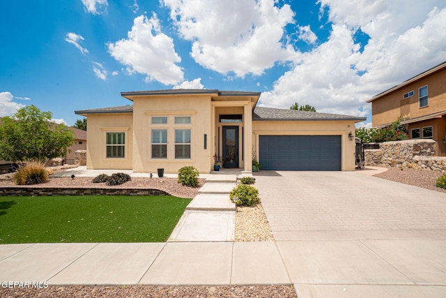 7317 Kiowa Creek Dr, El Paso, TX 79911 - prairie-style home featuring an attached garage, stucco siding, driveway, and a front yard