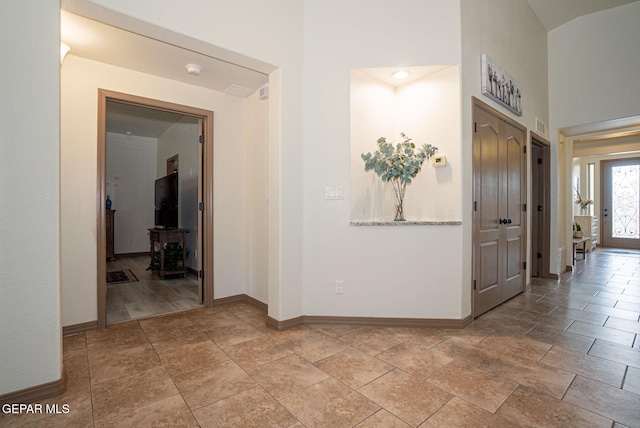 7317 Kiowa Creek Dr, El Paso, TX 79911 - corridor featuring light stone finish floors and a high ceiling